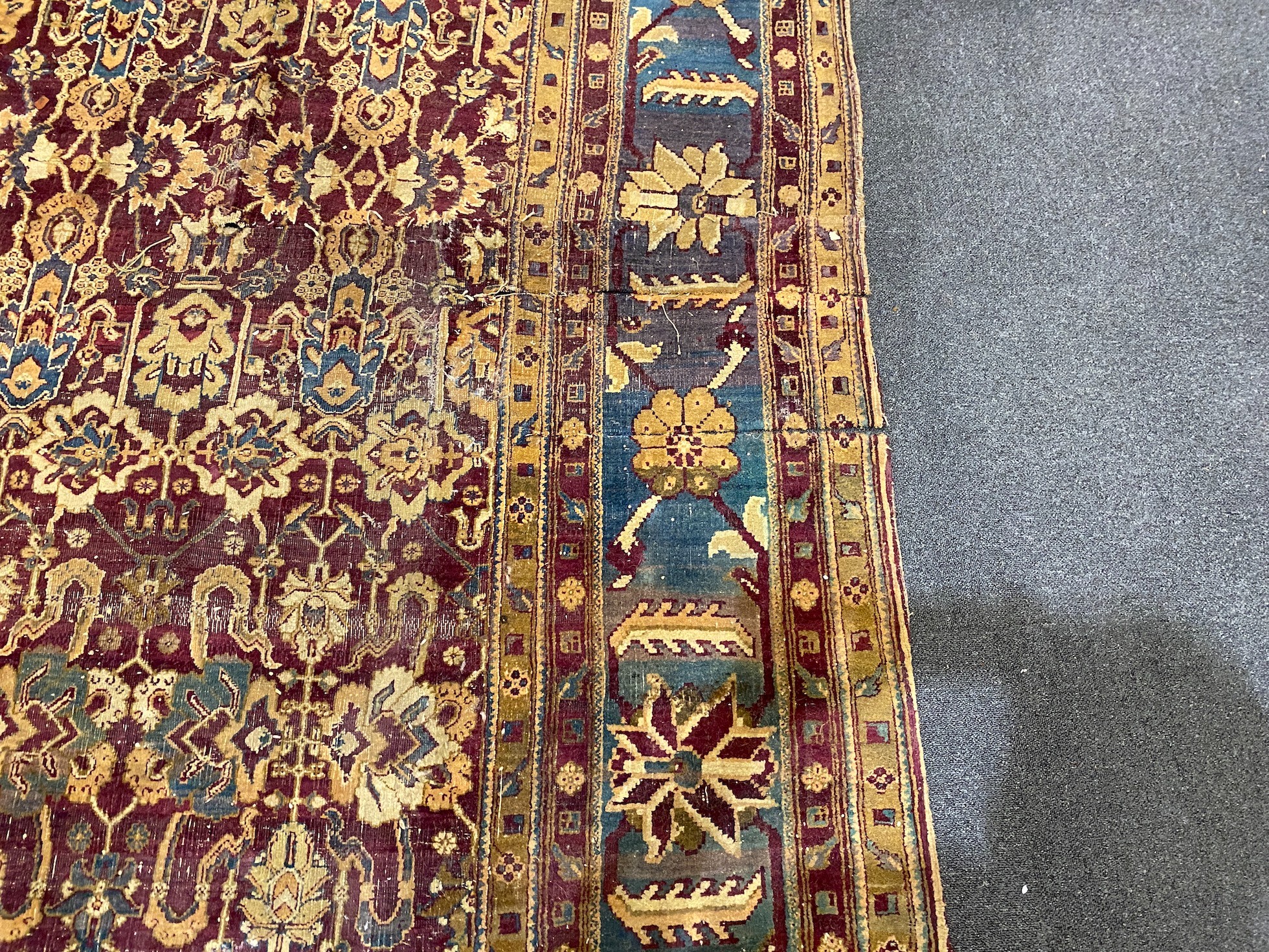 A large Sarouk purple ground carpet, approx. 20ft x 12ft. (cut in one area)